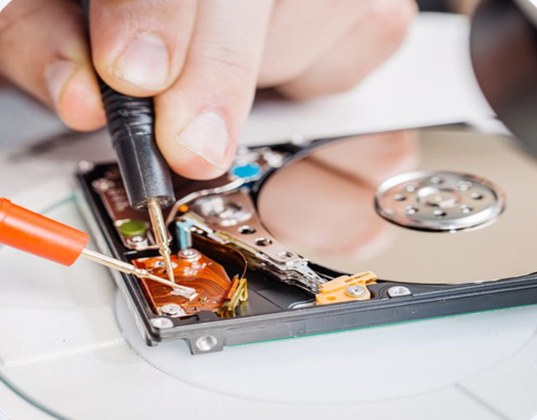 Data recovery technician working on a hard drive